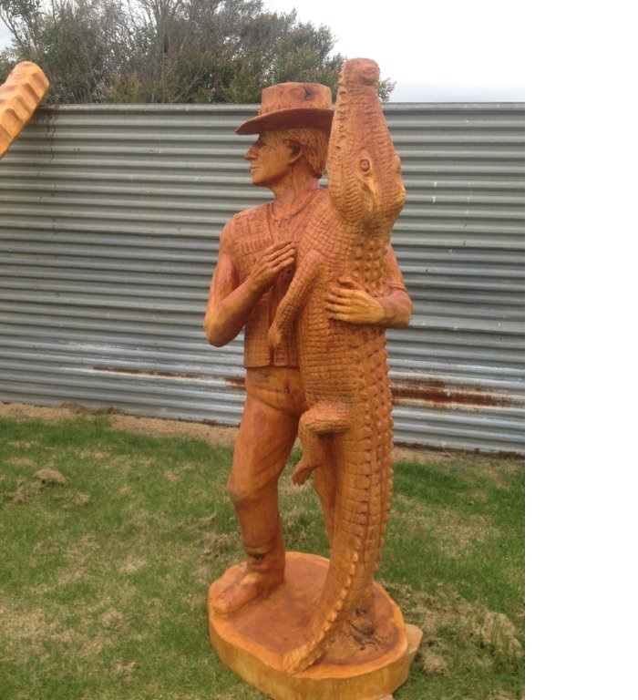 To win an Australian Chainsaw carving competition, John Brady carves  Mick Crocodile Dundee