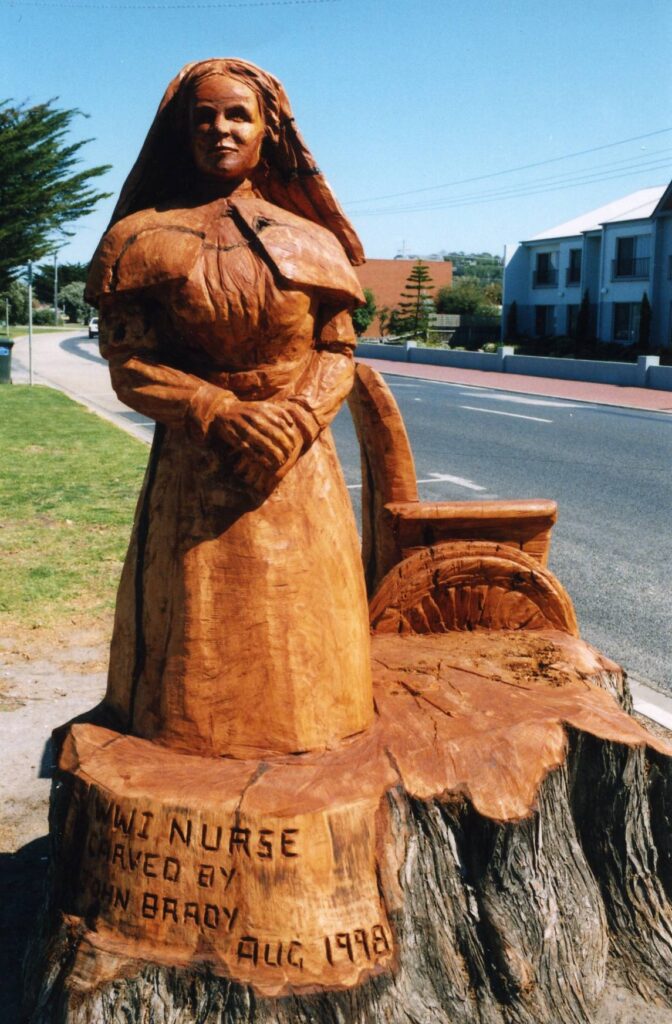 Chainsaw carved WW1 Nurse in Lakes Entrance, carved from a Tree Trunk by John Brady