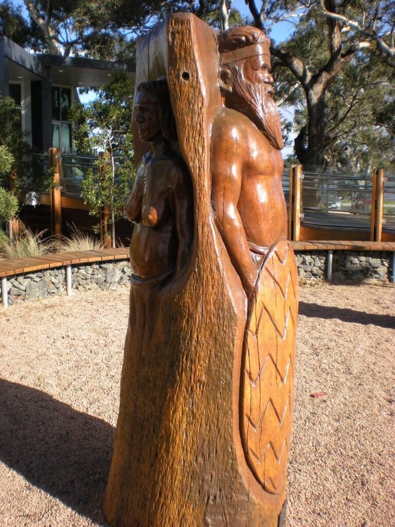 Sale Park-Aboriginal hunter and his wife carved by John Brady using Chainsaws - View 2