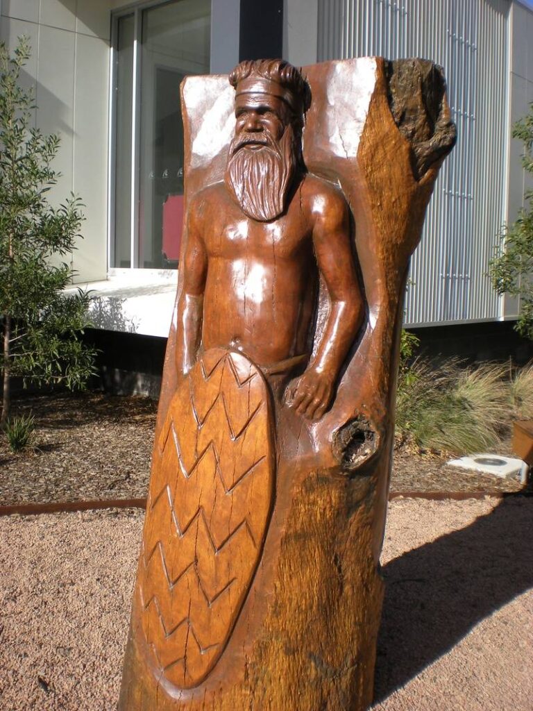 Sale Park-Aboriginal hunter and his wife carved by John Brady using Chainsaws - View 1